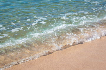 small wave on sandy beach