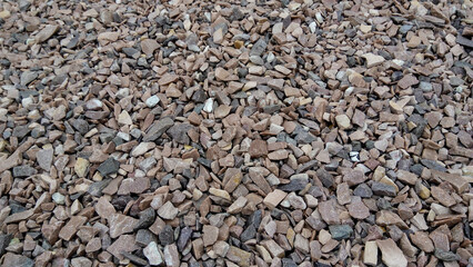 Close up of a lot of dried gravel stones. Scenic view of natural stone background. Industrial backdrop of modern build of the city road.