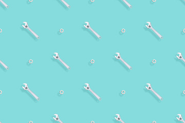 Adjustable metal wrench seamless pattern. Background from a metal wrench and nut. 
