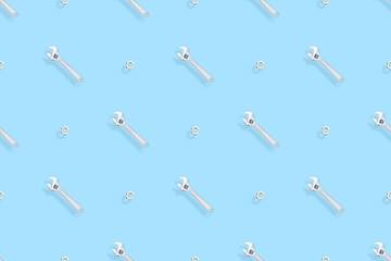 Adjustable metal wrench seamless pattern. Background from a metal wrench and nut. 