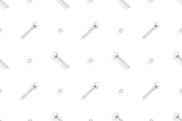 Adjustable metal wrench seamless pattern. Background from a metal wrench and nut. 