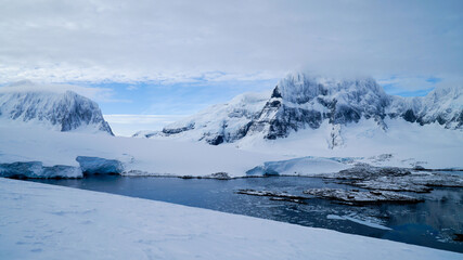 Snow covered Mountains and Icebergs in the Antarctic Peninsula on Antarctica.