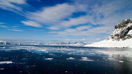 Snow covered Mountains and Icebergs in the Antarctic Peninsula on Antarctica.