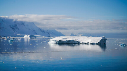 Snow covered Mountains and Icebergs in the Antarctic Peninsula on Antarctica.