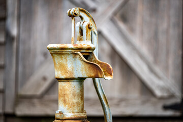 Old Time Hand Water Pump in Front of Barn Door