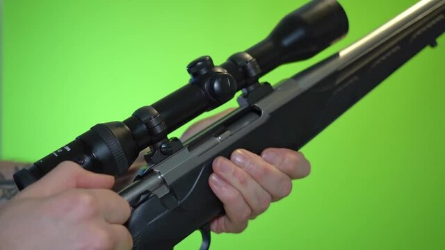 Pulling back end piece and reloading rifle by putting new cartridge into chamber - slow motion green screen chroma key