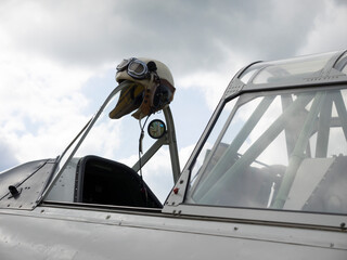 Classic aviator hat on an airplane windshield
