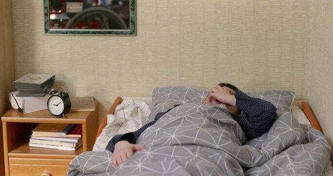 A teenage boy with a disability wakes up in the morning and cannot get in a wheelchair. The lives of children with disabilities and paralysis of the spine