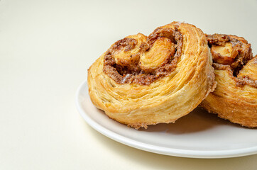 French sweet bun. On a white plate High quality photo