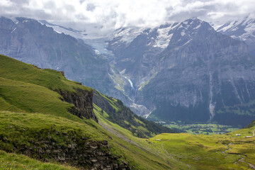 Fototapeta na wymiar The Grindewald Valley and mountain pastures in Switzerland 
