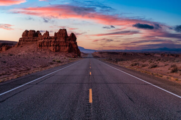 Middle of the Road View of a Scenic route in the desert. Colorful Sunrise Sky Art Render. Taken on Route 24, Utah, United States of America.