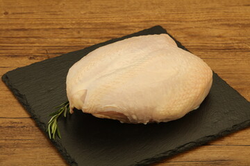 Raw whole chicken breast with skin