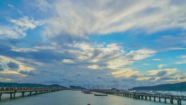 time lapse cloudy in stuning red sky above Chalong pier..Chalong marina is a center for intense boating activity in Phuket..4K UHD Stock video for tourism and nautical concepts.