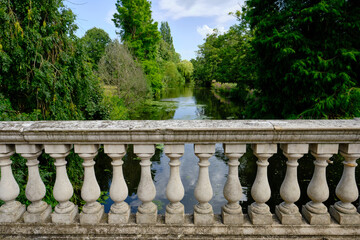 View of Italian Palladio balustrade in the foreground and beautiful forest and river in the...