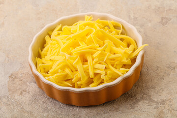 Shredded yellow cheese in the bowl