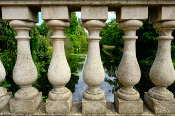 Fototapeta na wymiar Close-up of Italian Palladio balustrade. Beautiful forest and river in the background.