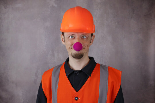 Crazy desperate worker with a funny expression with a clown nose