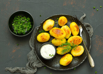 baked young potatoes with white sauce. View from above.