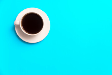 Cup of coffee is on a blue background.