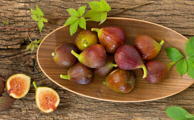 Fresh fig fruits on a wooden background.