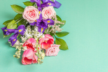 A beautiful bouquet of fresh flowers on a turquoise pastel background