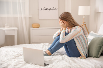 Stressed young woman asking psychologist for advice online at home