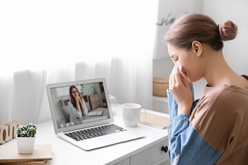 Stressed young woman asking psychologist for advice online at home