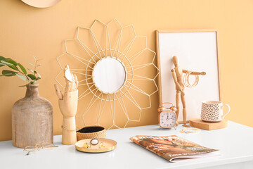 Stylish decor with female jewelry and fashion magazine on dressing table