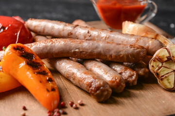 Board with delicious grilled sausages, closeup