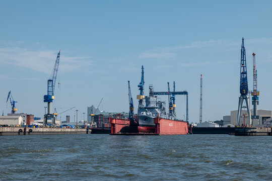 German naval ship in the Blohm + Voss Shipyard Port of Hamburg undergoing repair or construction (HAMBURG, GERMANY – AUGUST 24, 2019)