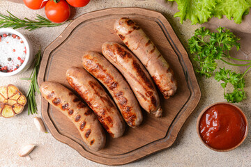 Board with delicious grilled sausages on wooden background