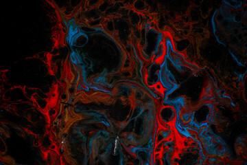 Fototapeta premium Texture in the style of fluid art. Abstract background with swirling paint effect. Liquid acrylic paint background. Black, blue and red colors.