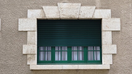 window with green shutters on the facade