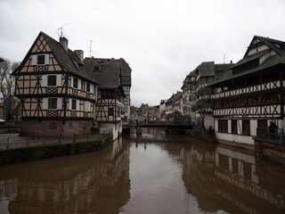 Old traditional architecture half-timbered houses buildings at Petite France Ill Rhine river...