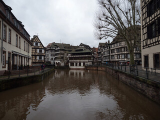 Old traditional architecture half-timbered houses buildings at Petite France Ill Rhine river...