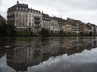 Old traditional architecture half-timbered house reflection at Petite France Ill Rhine river...