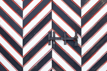 old striped wooden gates locked, closed customs entry or border control, army unit or facility...