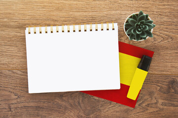 notebook empty with place for text on spanish, pen, spain flag, marker on wooden brown desktop 