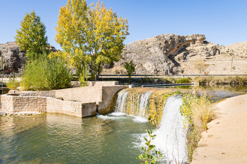 Obraz premium a weir in Ucero river next to El Burgo de Osma-City of Osma, province of Soria, Castile and Leon, Spain