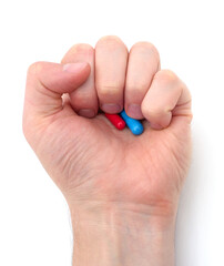 Fist with red and blue capsule.