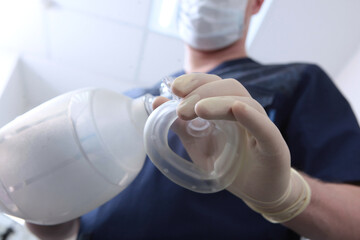 Anesthesiologist holds a spare set of medical equipment for breathing in his hand.Preparation for...
