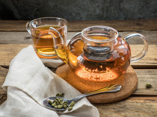 Ginseng tea in a teapot . Ginseng Oolong tea brew in a teaspoon , a teapot and a cup of ginseng oolong tea on a wooden table.  