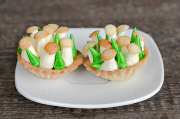 Cake in the form of a basket of shortbread cake with mushrooms. Shallow depth of field, selective focus
