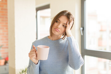 pretty woman feeling bored, frustrated and sleepy after a tiresome, dull and tedious task, holding...