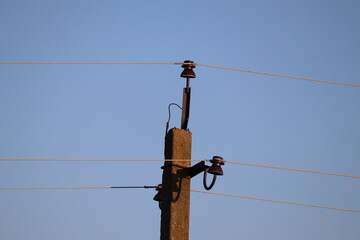 Power transmission pole in the field. Spring.