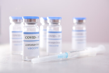 Vaccine ampoules and syringe, coronavirus pandemic and vaccination