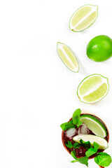 Moscow mule alcoholic cocktail in copper mug with lime, ginger beer, vodka and mint. White table background, copy space