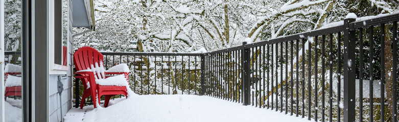 Winter storm, residential deck covered in fresh snow in a winter wonderland
