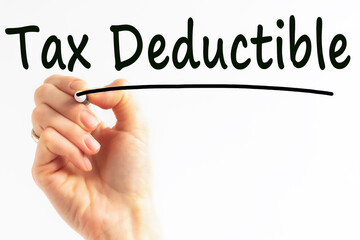 hand writing inscription tax deductible with marker, concept, stock image