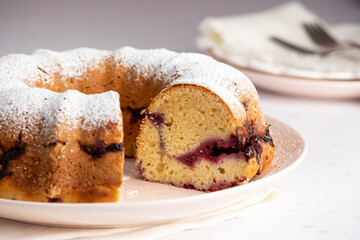 Raspberry Breakfast Bundt Cake with one slice removed to show marbling.